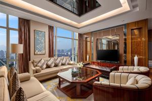 a living room with a couch and a tv at Crowne Plaza Taizhou by IHG in Taizhou