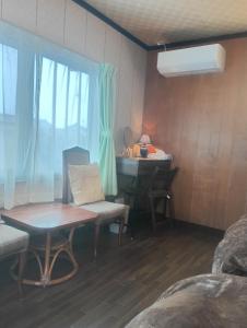 a small room with a table and a desk at 波松の家 in Awara