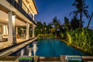 a swimming pool in the backyard of a villa at Sunset Pandawa Villa in Ubud