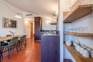a kitchen and dining room with a table and chairs at Flateli Santa Clara 31 in Girona +15 photos