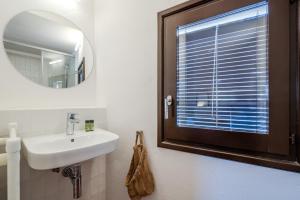 a bathroom with a sink and a mirror at Flateli Santa Clara 31 in Girona