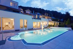 a swimming pool in the backyard of a house at Wiedemann's Weinhotel in Sankt Martin
