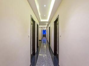 a hallway of a hotel with a blue light in the ceiling at Hotel Anchal Villa By YB Hotel in Udaipur