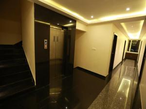 a hallway with stairs and a elevator in a building at Hotel Anchal Villa By YB Hotel in Udaipur