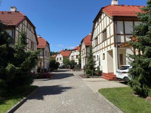 a cobblestone street in a town with houses at Sea You Beach House in Rogowo