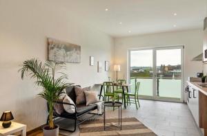a kitchen and living room with a table and chairs at Mina in Geratskirchen +2 photos