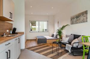 a kitchen and living room with a bed and a couch at Mina in Geratskirchen