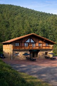 a building with a deck on the side of it at Casa Kirana - Habitaciones in Bermeo