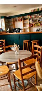 a wooden table and chairs in a restaurant at Auberge de l'eau rousse in La Léchère +13 photos