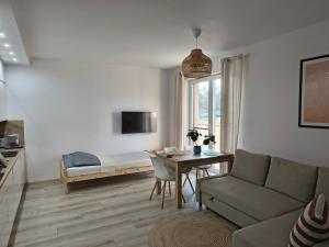 a living room with a couch and a table at Przystań Natura Apartamenty nad rzeką, cisza i rowery in Iława +62 photos