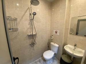 a bathroom with a shower and a toilet and a sink at Lifto Hostel in Voyvodinovo +11 photos