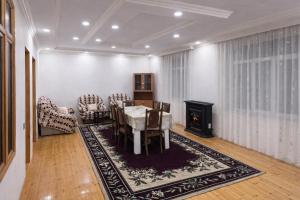 a dining room with a table and chairs and a fireplace at İvanovka Eco Home in İvanovka