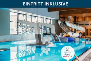 a large swimming pool with a water slide at Marissa Resort in Lembruch