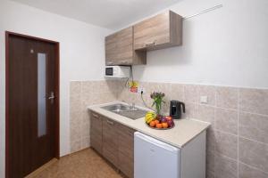 a kitchen with a bowl of fruit on a counter at Hotel Hůrka in Pardubice