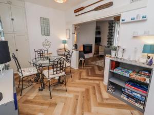 a dining room and living room with a table and chairs at Sea Mist in Newbiggin-by-the-Sea