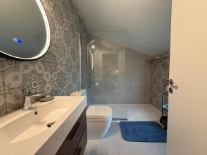 a bathroom with a toilet and a sink and a mirror at Cyherbia Botanical Park & Labyrinth in Avgorou +15 photos