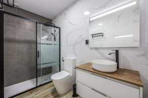 a bathroom with a toilet and a sink and a shower at Polán Living | New Apartment - B in Polán