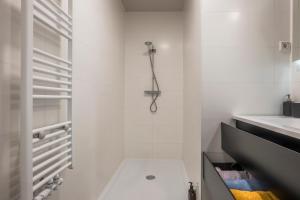 a white bathroom with a shower and a sink at The Carriage House - Historic 3-Bedroom Apartment near Utrecht - Huize de Lekpoort Vianen in Vianen +21 photos