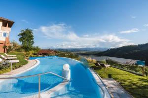 a swimming pool with a view of a mountain at das kappel wein gut hotel in Kitzeck im Sausal