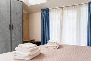 a room with a bed with folded towels on it at Hotel Doria in Bellaria-Igea Marina +73 photos