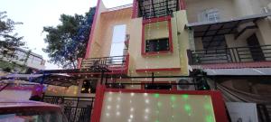 a building with christmas lights in front of it at Cozzy in Nagpur