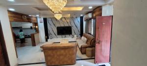 a living room with a couch and a tv at Cozzy in Nagpur