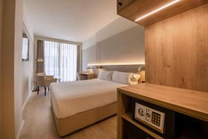 a hotel room with a bed and a desk at Hotel Marina in Roses
