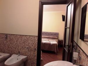 a bathroom with a sink and a toilet and a bed at Villa Lucia in Lampedusa +37 photos