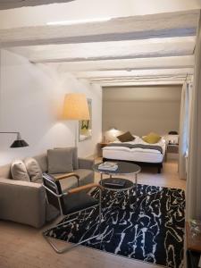 a living room with a couch and a table at Baseltor Hotel & Restaurant in Solothurn