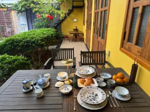 a wooden table with a plate of food on it at Hoàng Doji de Villa in Thôn Dương Xuân Hạ