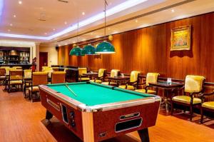 a pool table in a room with a bar at Sunday Hotel Al Barsha Dubai Mall of the Emirates Formerly Grand Excelsior Al barsha in Dubai