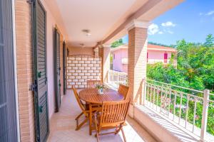 a patio with a table and chairs on a balcony at Incantea Resort in Tortoreto Lido