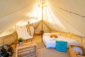 a bedroom with two beds in a tent at Bungalows & Glamping Conil Playa in Conil de la Frontera +62 photos