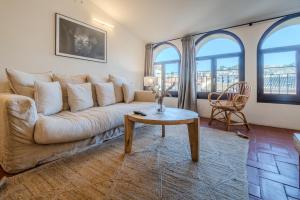 a living room with a couch and a table at Flateli Santa Clara 22 in Girona