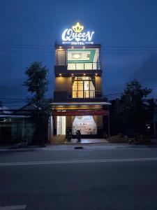 a lit up building with a sign on top of it at Queen hotel in Cù Lao Nai