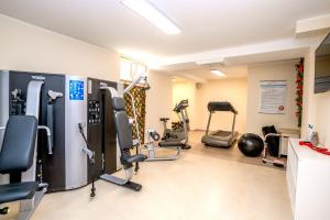 a gym with several treadmills and exercise bikes at Incantea Resort in Tortoreto Lido
