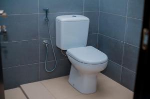 a bathroom with a white toilet and a shower at Coastal Escape Haven in Mchamba Wima
