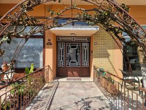an entrance to a house with a wooden door at B&M Cozy Corner in Igoumenitsa