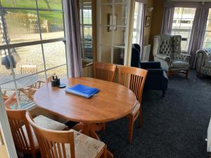 a table with a blue book on it in a room at Bridge Farm Caravan in Buxton