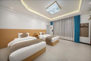 a hotel room with two beds and a skylight at First encounter with a homestay in Fenghuang County