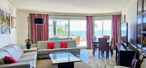 a living room with a couch and a table at Coral Beach Aparthotel in Marbella
