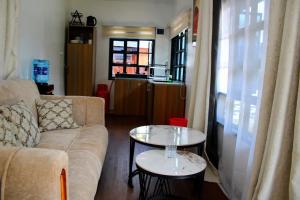 a living room with a couch and two tables at Maya Stays in Busia