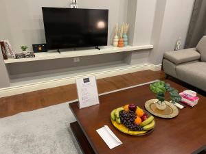 a living room with a table with a plate of fruit at Maison 7 Residence in Obour
