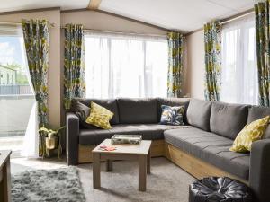 a living room with a couch and a table at Baywood View in East Heslerton