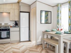 a kitchen with a table and a refrigerator at Baywood View in East Heslerton