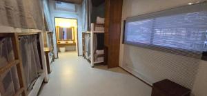 a hallway of a room with a window and a bathroom at Calamianes Homestay in Coron