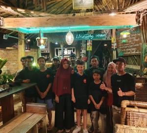 a group of people posing for a picture in a restaurant at Satu Lingkung in Tetebatu