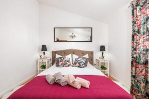 a bedroom with a bed with two pairs of slippers at House with pool and whirlpool in Sarići +50 photos