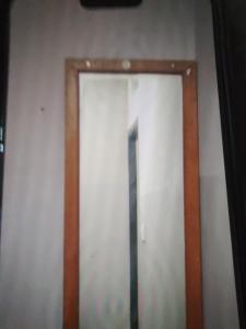 a mirror on a wall in a room at Sri Krishnaa comforts in Bangalore