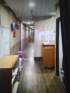 a hallway of an office with a desk and a counter at Sri Krishnaa comforts in Bangalore